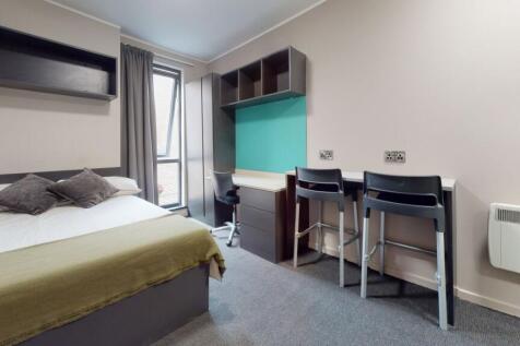 A clean and modern student room featuring a com...