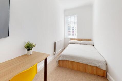 A bright and airy double bedroom featuring a co...