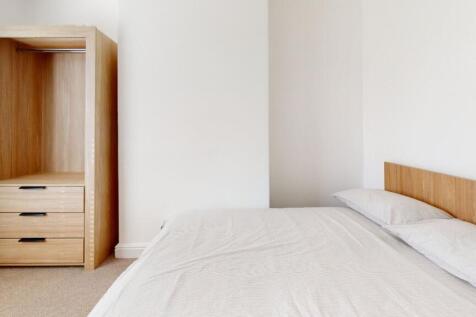 A neatly presented bedroom showcasing a comfort...