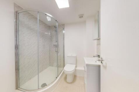 A clean and bright modern bathroom with a corne...