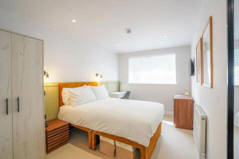 Bright and inviting master bedroom with a large...