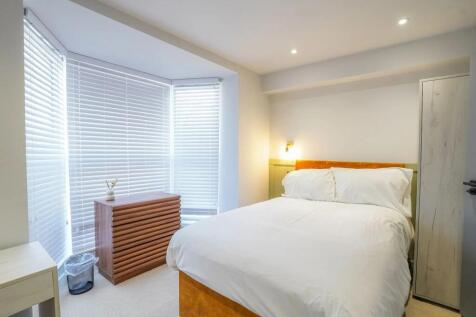 Bright and spacious master bedroom featuring a ...