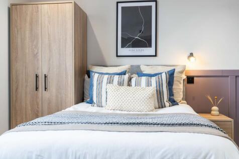 A spacious, well-maintained master bedroom feat...