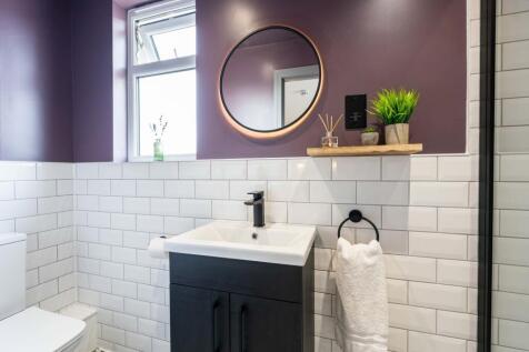 Modern bathroom featuring a sleek sink with sto...