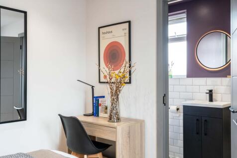 Modern bathroom with a black vanity unit, white...