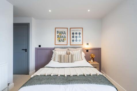 Bright and stylish master bedroom featuring a n...