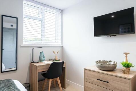 Bright and modern living room featuring a large...