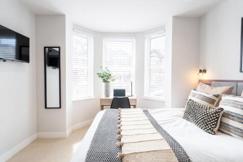 Bright and spacious master bedroom featuring a ...