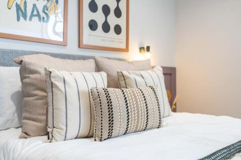 A spacious and inviting bedroom featuring a nea...