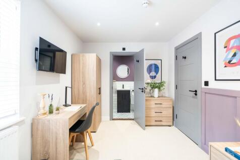 A bright and modern bedroom featuring a large w...