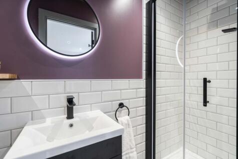 Modern bathroom featuring stylish white subway ...