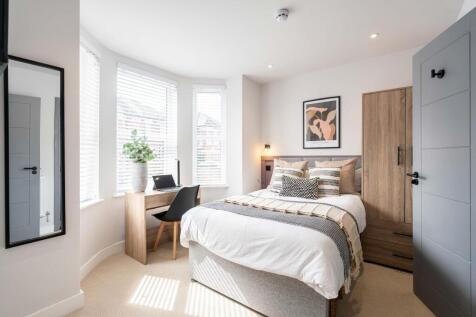 Bright and welcoming master bedroom featuring n...