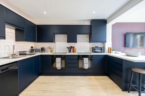 Modern and stylish kitchen featuring sleek navy...