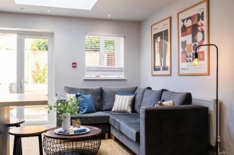 Bright and stylish living room featuring a comf...