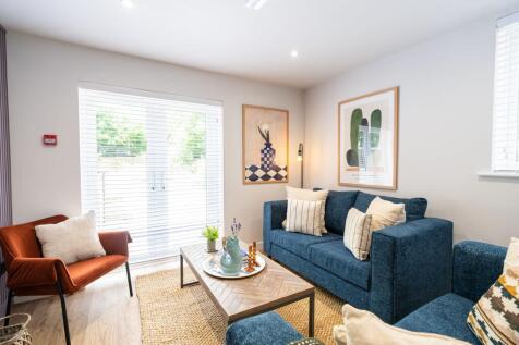 Bright, contemporary living room featuring a la...