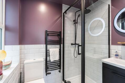 Modern bathroom featuring a stylish shower encl...