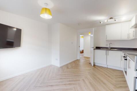 Bright, modern living area with ample natural l...