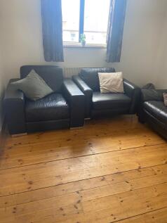 A cozy living room with comfortable seating, pe...
