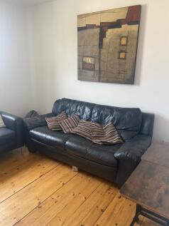 A cozy living room featuring a comfortable leat...