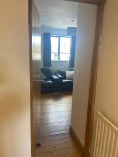 A cozy and inviting living room with ample natu...