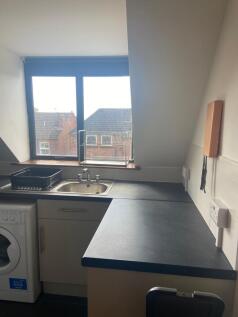 A bright and tidy kitchenette with ample counte...