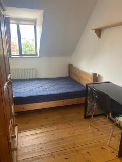 A bright and tidy double bedroom featuring ampl...