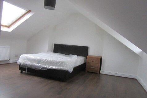Bright and spacious attic bedroom featuring a c...