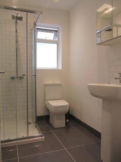 A bright and clean modern bathroom featuring a ...