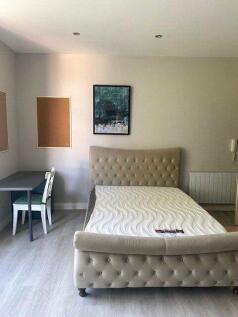 A bright and neatly arranged double bedroom fea...