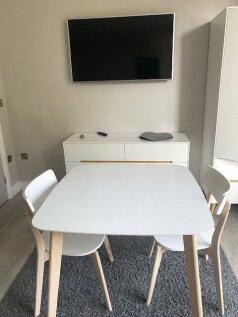Bright communal lounge featuring a modern white...