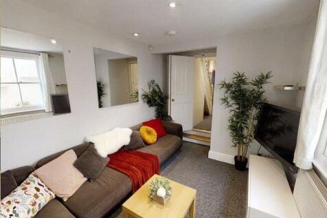 A bright, inviting living room featuring comfor...