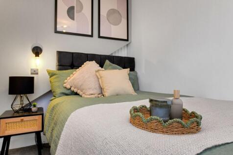 A beautifully decorated master bedroom featurin...