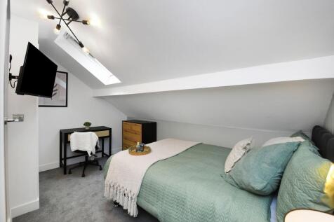Spacious master bedroom with modern decor, natu...