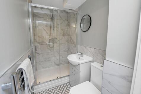 Modern bathroom featuring a spacious shower wit...