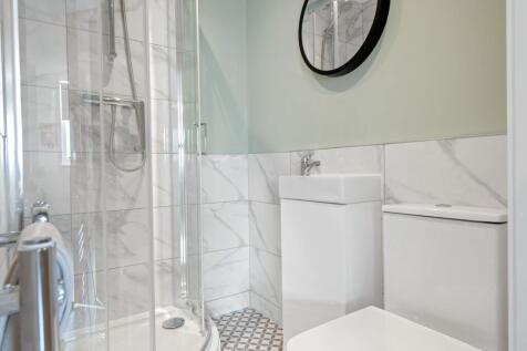 Modern, clean bathroom with a spacious shower e...