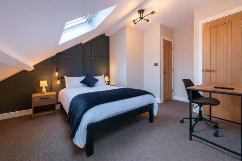 A modern and inviting master bedroom featuring ...