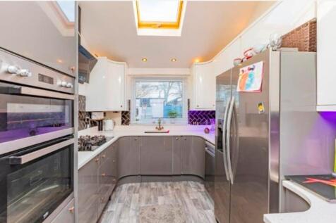 A modern and tidy kitchen with a skylight provi...