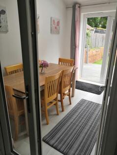 A clean and well-lit kitchen with a dining tabl...