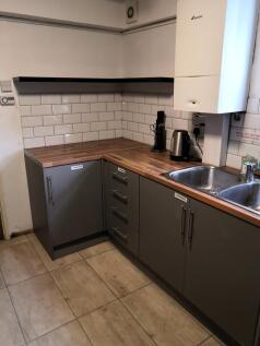 A modern kitchenette featuring sleek cabinetry ...