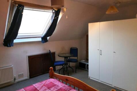A cozy double bedroom with a skylight and basic...