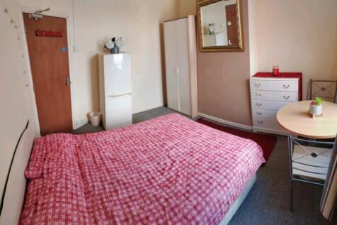 A cozy double bedroom featuring a red checkered...