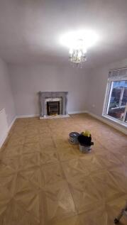 Spacious and well-lit living room with a large ...
