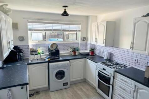 Bright and tidy kitchen with ample counter spac...
