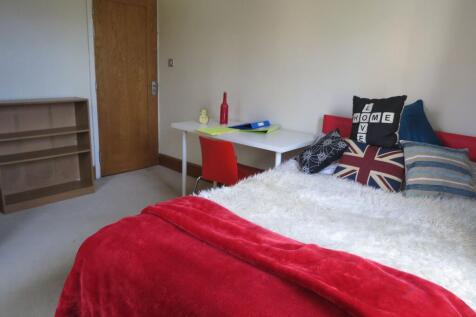 A cozy double bedroom featuring a bed with deco...