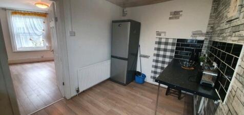 A compact kitchen area featuring a small refrig...