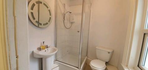 A clean and functional bathroom featuring a sho...