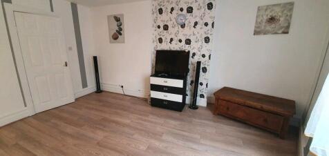 A bright, spacious living room featuring a mode...