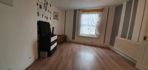 A bright and spacious living room with a large ...