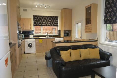 A modern kitchen with ample cabinetry, black co...