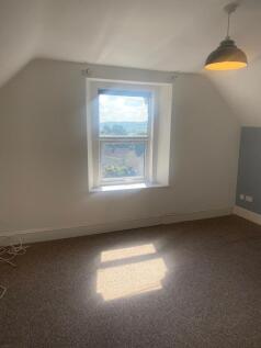 Bright and airy bedroom with a large window off...